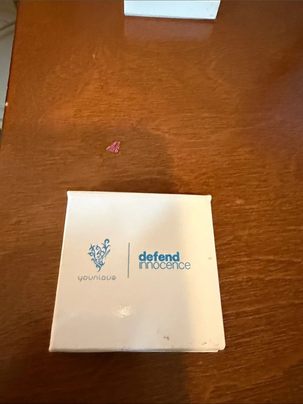 Younique White Compact Case‎ with Blue Defend Innocence Logo